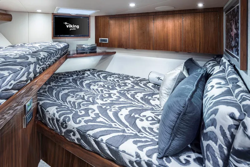 Slide: The Image of Manufacturer Provided Image: Luxurious cabin interior of 2026 Viking 58 Convertible yacht with elegant bedding and wood finishes. - 14