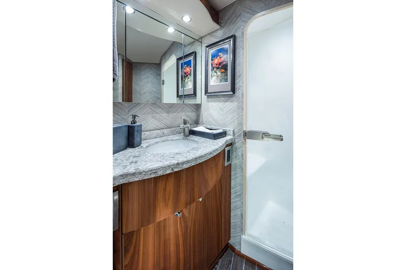 Slide: The Image of Manufacturer Provided Image: Luxurious bathroom in 2026 Viking 58 Convertible yacht with modern fixtures and elegant wood cabinetry. - 16