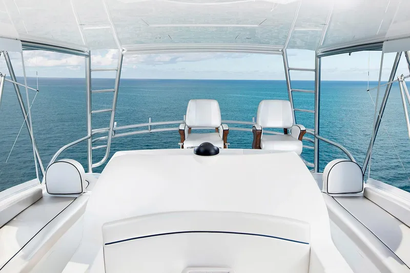 Slide: The Image of Manufacturer Provided Image: 2026 Viking 58 Convertible yacht helm with ocean view, featuring sleek design and modern seating. - 6