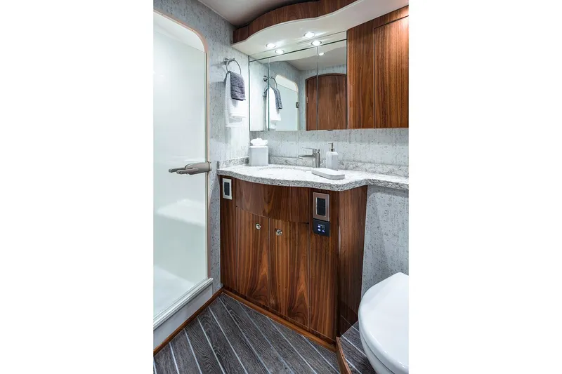 Slide: The Image of Manufacturer Provided Image: Luxurious bathroom in 2026 Viking 58 Convertible yacht with wood cabinetry and modern fixtures. - 17