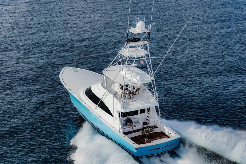 Slide: The Image of Manufacturer Provided Image: 2026 Viking 58 Convertible yacht cruising on open water. - 1