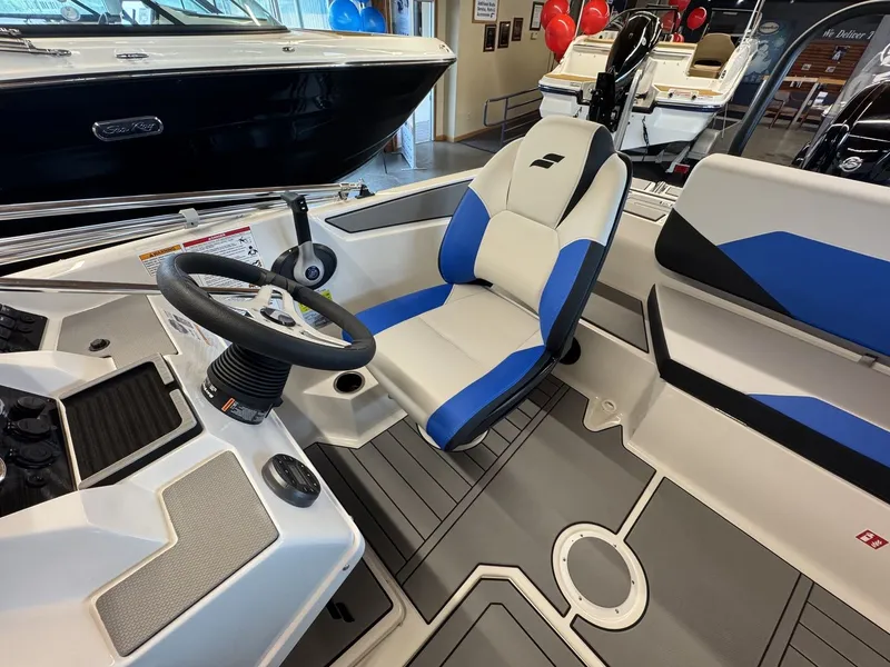Slide: The Image of The image shows the cockpit of a 2026 Starcraft 181SVOB boat with modern seating and controls. - 6