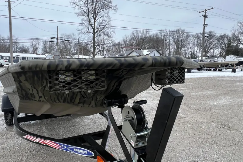 Slide: The Image of 2026 SeaArk 1648 MV Special boat on trailer in snowy outdoor setting. - 2