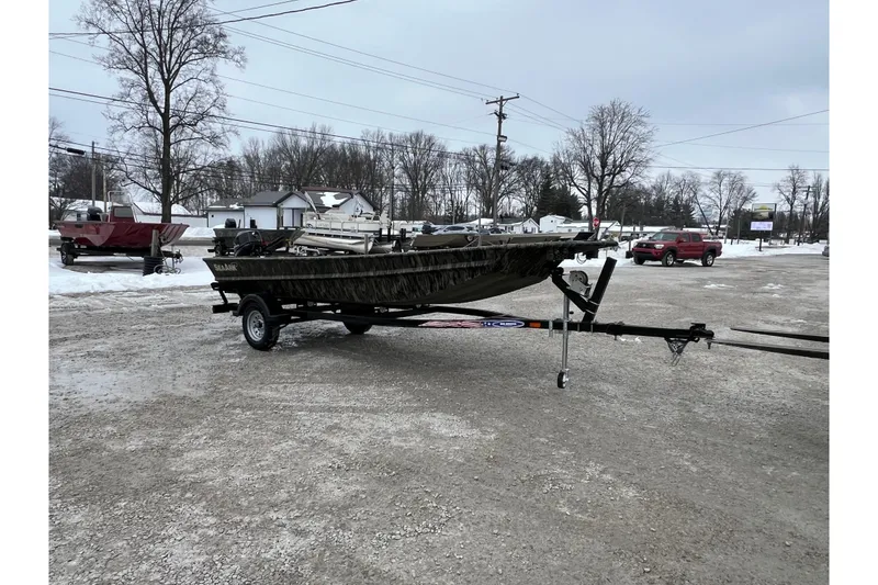 Slide: The Image of 2026 SeaArk 1648 MV Special boat on trailer in snowy parking lot. - 6