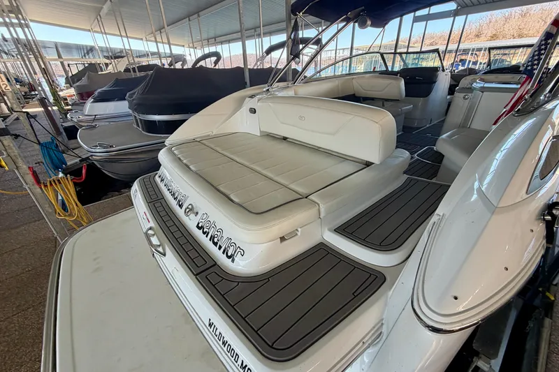 Slide: The Image of 2007 Cobalt 302 boat with white seating, docked in a covered marina. - 10