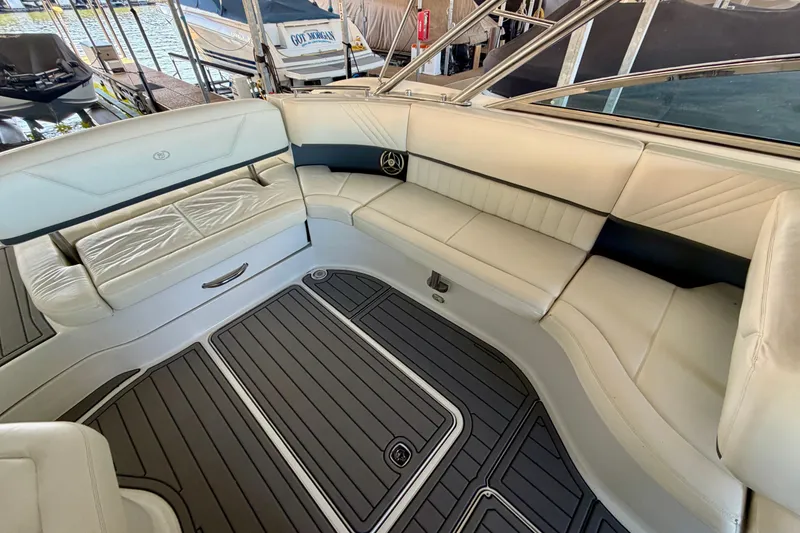 Slide: The Image of Luxurious interior of a 2007 Cobalt 302 boat with white seating and sleek flooring. - 15