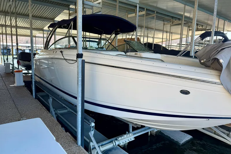 Slide: The Image of 2007 Cobalt 302 boat docked in a covered marina, side view. - 2