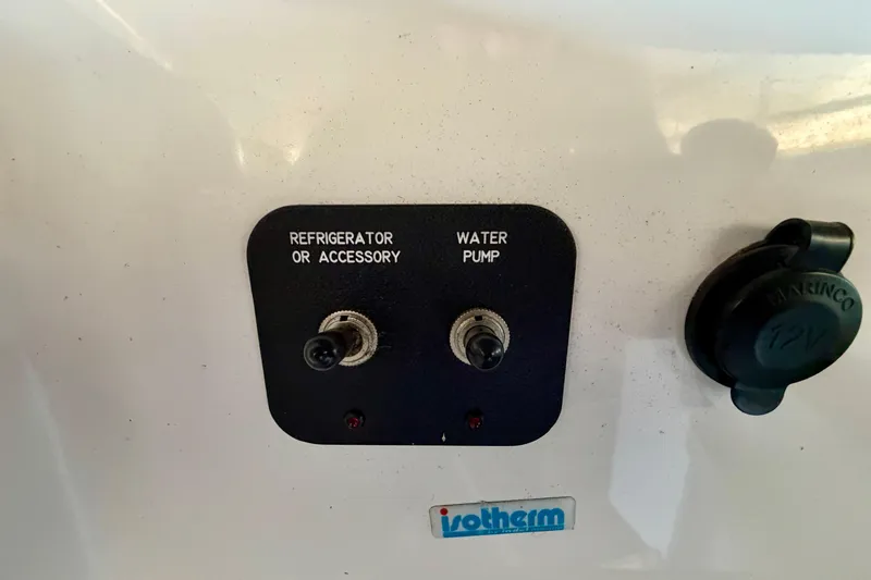 Slide: The Image of Control panel with switches for refrigerator, water pump, and 12V outlet on 2007 Cobalt 302. - 22