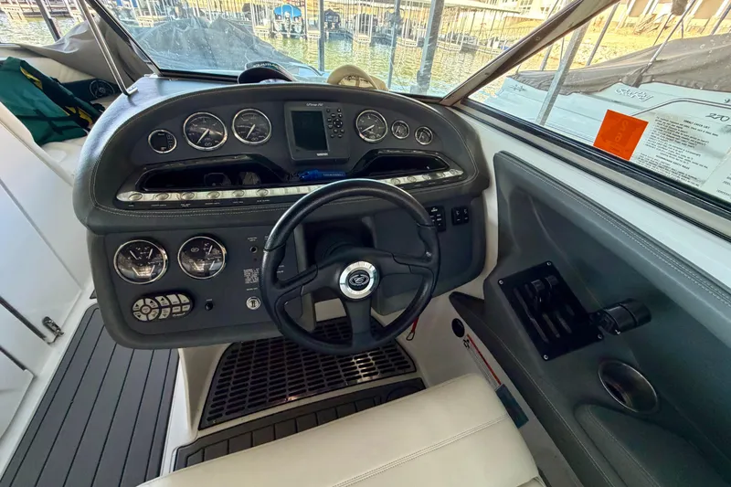 Slide: The Image of Interior view of a 2007 Cobalt 302 boat dashboard with steering wheel and gauges. - 25