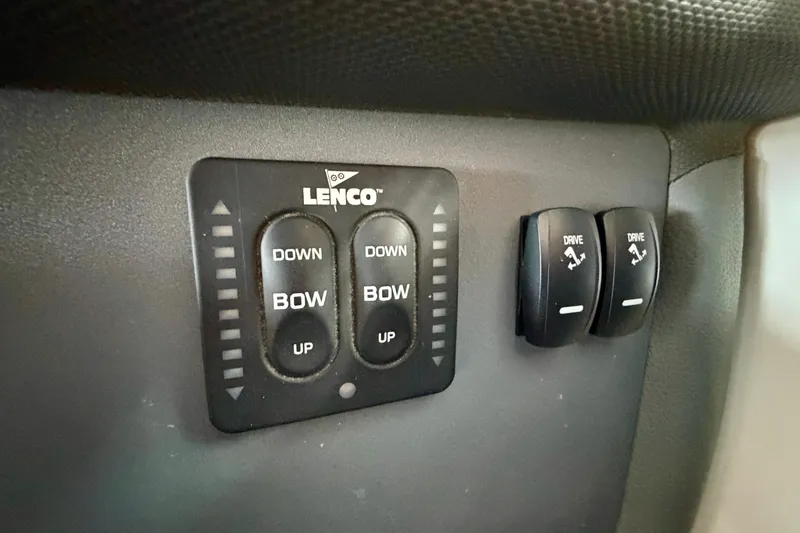 Slide: The Image of Lenco trim tab controls on 2007 Cobalt 302 boat dashboard. - 26