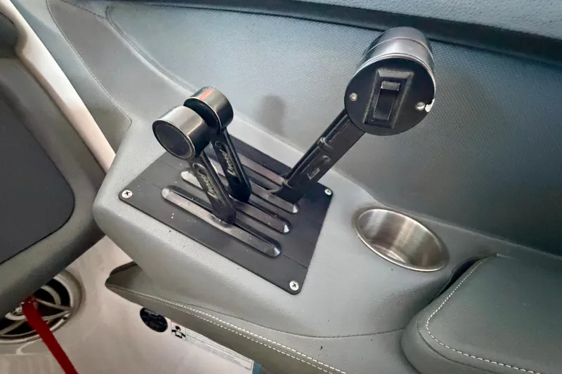 Slide: The Image of Throttle controls of a 2007 Cobalt 302 boat, featuring dual levers and a cup holder. - 27