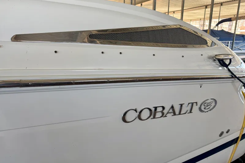 Slide: The Image of 2007 Cobalt 302 boat side view with logo and chrome details. - 3