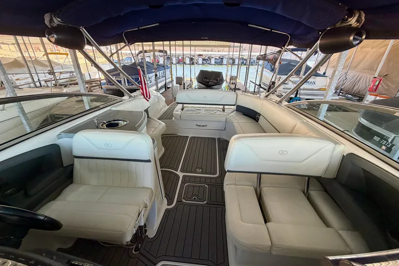 Slide: The Image of Interior of a 2007 Cobalt 302 boat with white seating and wood flooring. - 36