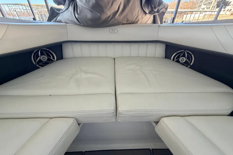 Slide: The Image of 2007 Cobalt 302 boat interior with white cushioned seating and speakers. - 40