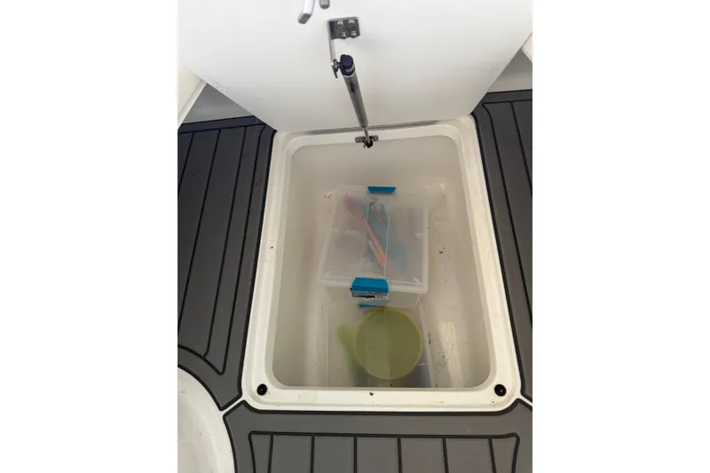 Slide: The Image of Storage compartment on 2007 Cobalt 302 boat with containers inside. - 42