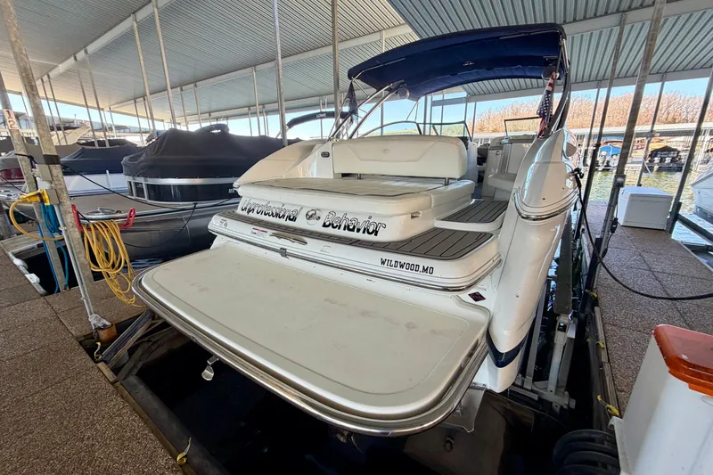Slide: The Image of 2007 Cobalt 302 boat docked in a covered marina, rear view. - 5
