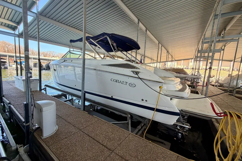 Slide: The Image of 2007 Cobalt 302 boat docked under a covered marina, side view. - 8