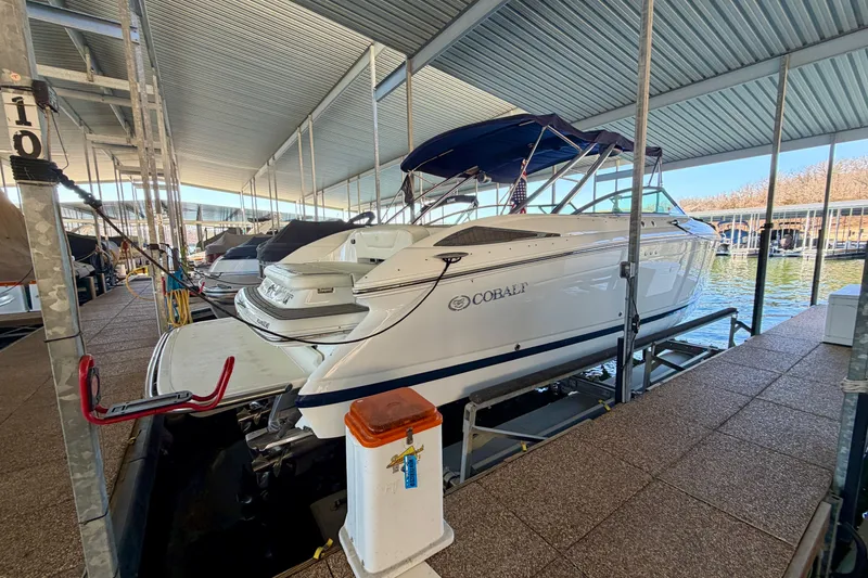 Slide: The Image of 2007 Cobalt 302 boat docked in a covered marina. - 9