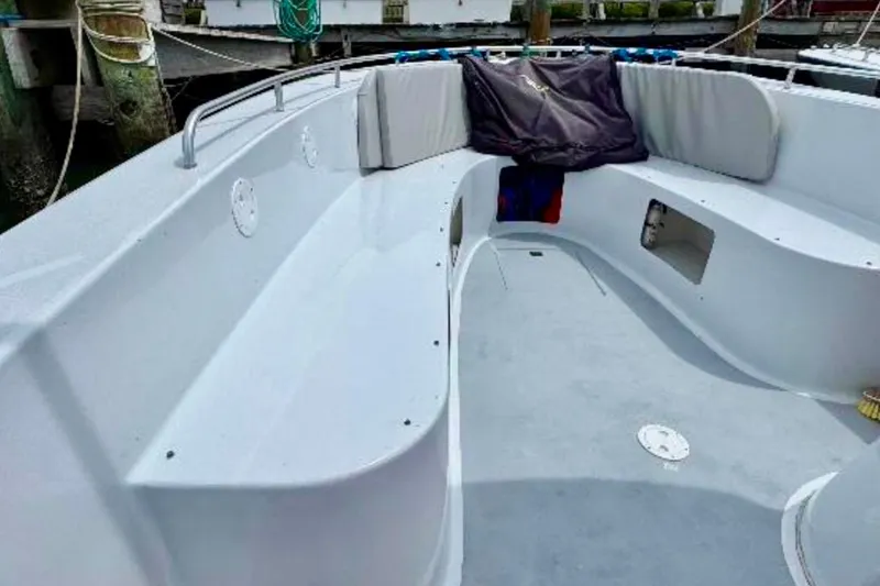 Slide: The Image of Open deck of a 2003 O.C. Parasail 28 boat with seating and storage. - 10