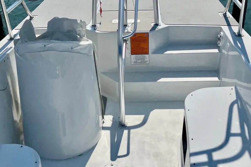 Slide: The Image of 2003 O.C. Parasail 28 boat interior with steps and railing, on calm water. - 13