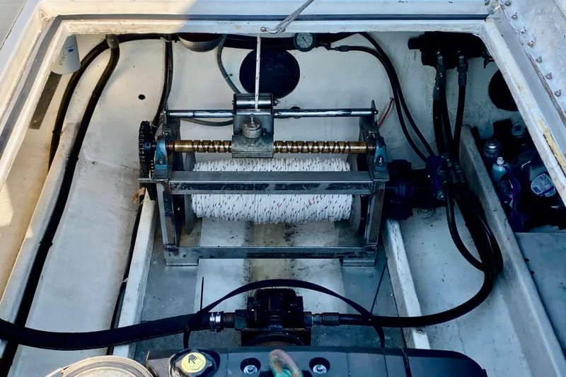 Slide: The Image of Engine compartment of a 2003 Custom O.C. Parasail 28 with visible winch and cables. - 22