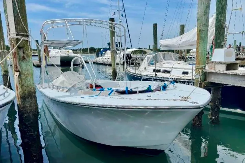 Slide: The Image of 2003 O.C. Parasail 28 boat docked in a marina, surrounded by other vessels. - 5