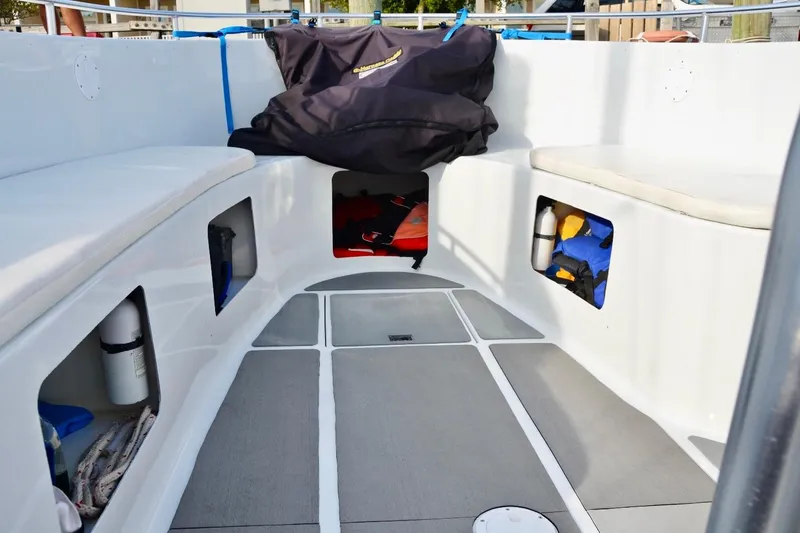Slide: The Image of Interior of 2003 O.C. Parasail 28 boat with storage compartments and seating. - 9