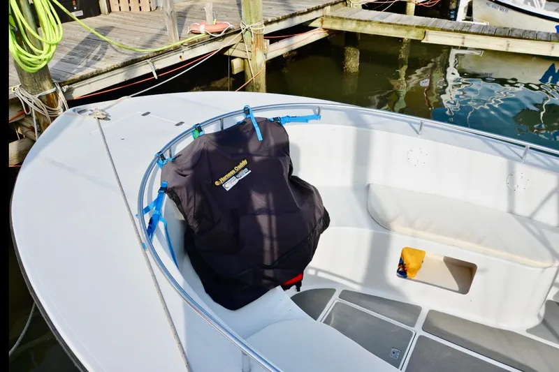 Slide: The Image of 2003 O.C. Parasail 28 boat docked, featuring a covered seating area and deck details. - 12