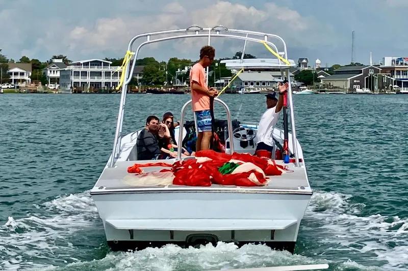 Slide: The Image of People on a 2003 O.C. Parasail 28 boat enjoying a water adventure. - 3