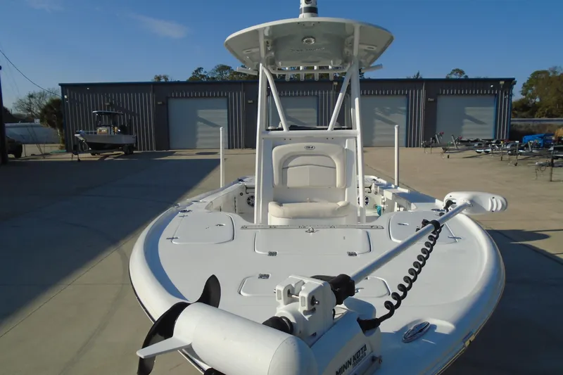 Slide: The Image of 2023 Sea Hunt BX 22 BR boat with Minn Kota trolling motor, parked outdoors. - 14