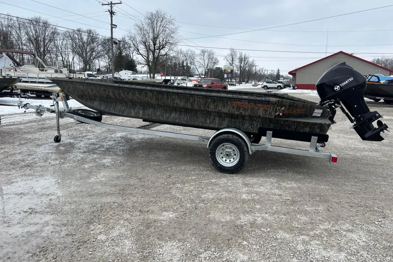The Image of 2026 SeaArk 1960 Slayer X boat on trailer, parked outdoors in snowy setting. - 0