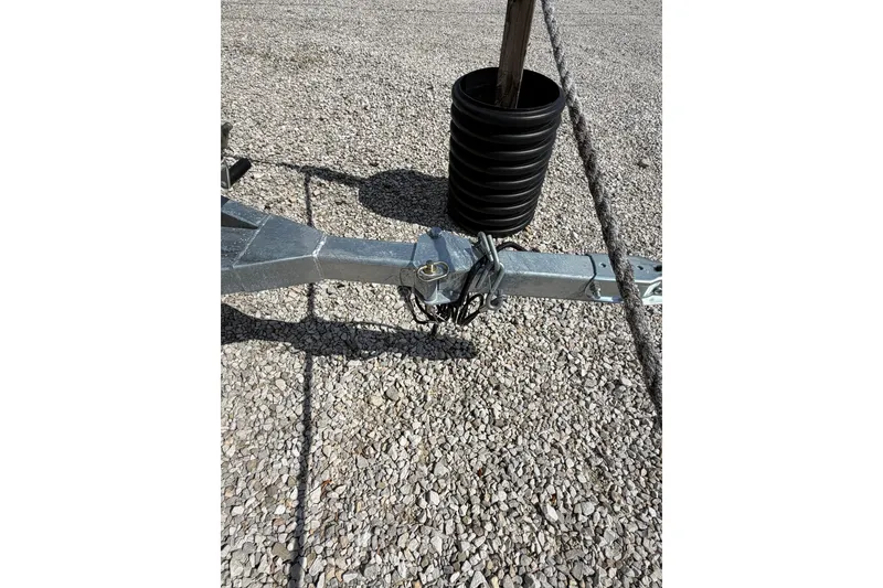 Slide: The Image of Trailer hitch of a 2026 SeaArk 1960 Slayer X on gravel surface. - 10