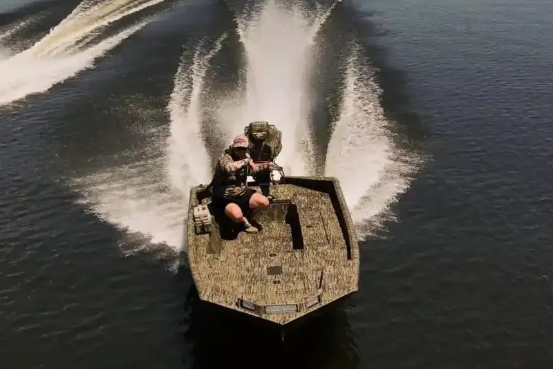 Slide: The Image of Manufacturer Provided Image: 2026 SeaArk 1960 Slayer Pro boats speeding on a serene lake. - 2