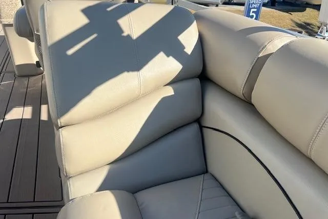 Slide: The Image of Beige leather seating on 2013 South Bay 722RS boat, with shadow and outdoor setting. - 12