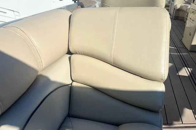 Slide: The Image of 2013 South Bay 722RS boat interior with beige leather seating and wood flooring. - 13