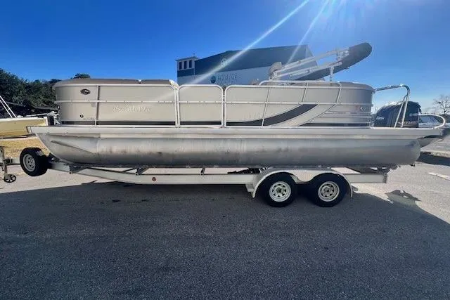 Slide: The Image of 2013 South Bay 722RS pontoon boat on a trailer under clear blue sky. - 4
