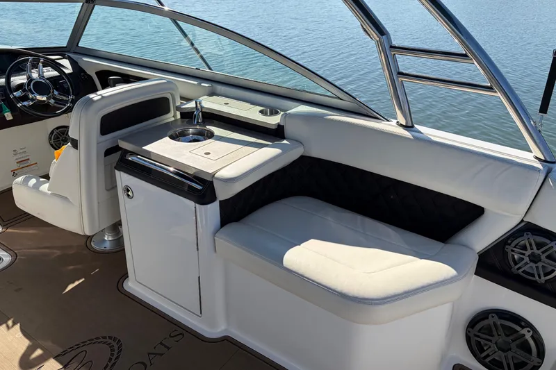 Slide: The Image of Interior of 2012 Cobalt A28 boat with seating and steering wheel, overlooking water. - 16