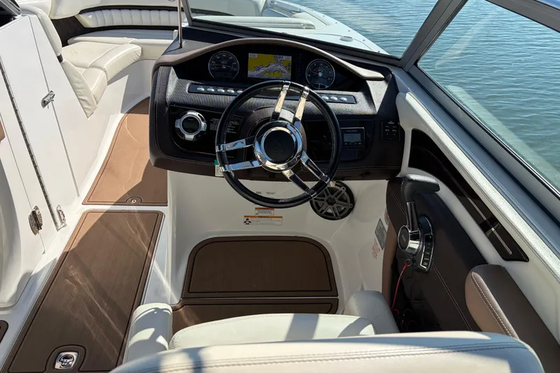 Slide: The Image of Interior of 2012 Cobalt A28 boat with steering wheel and dashboard controls. - 18
