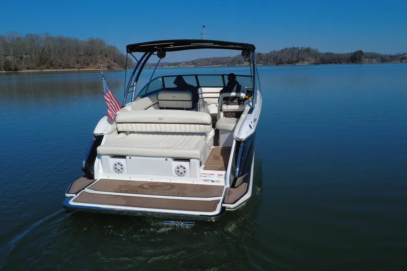 Slide: The Image of 2012 Cobalt A28 boat cruising on a calm lake under clear blue skies. - 3