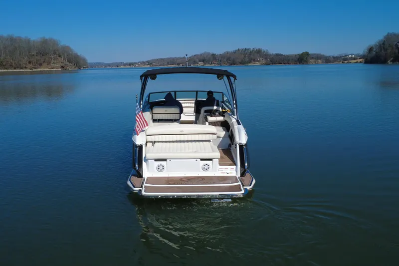 Slide: The Image of 2012 Cobalt A28 boat on a serene lake with clear blue skies. - 4