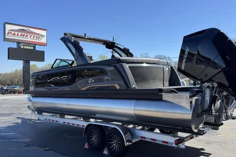 Slide: The Image of 2026 Godfrey Sanpan 2700 ULW pontoon boat on trailer at dealership. - 11