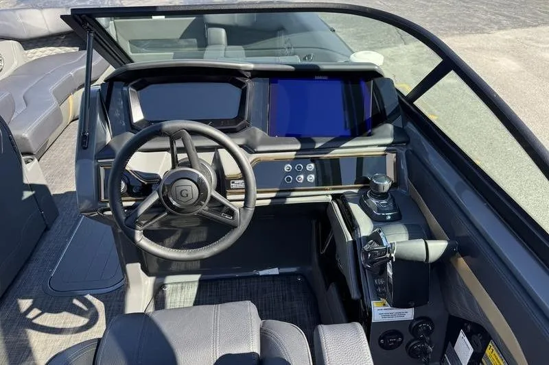 Slide: The Image of Interior view of 2026 Godfrey Sanpan 2700 ULW boat dashboard with steering wheel and controls. - 30