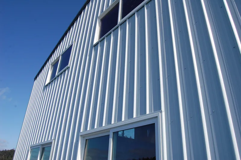 Slide: The Image of Metal-clad boathouse building with windows, blue sky. - 4