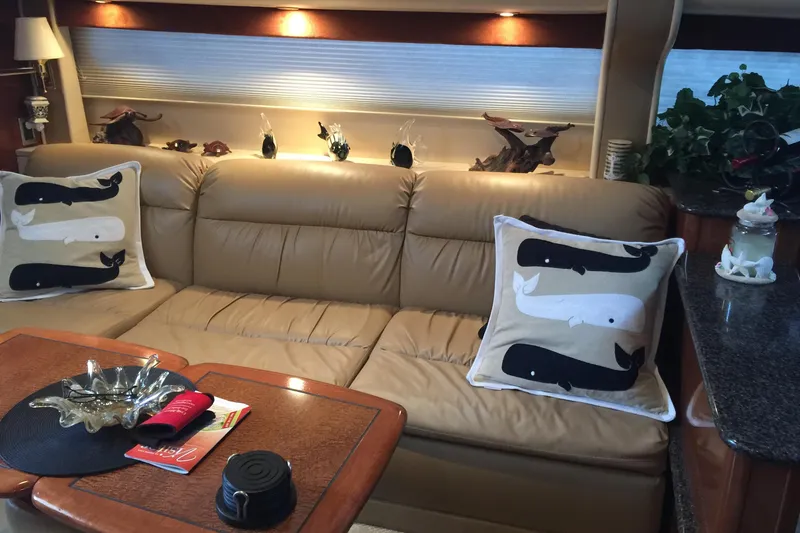 Slide: The Image of Luxurious 2006 Meridian 408 Motoryacht interior with beige leather sofa and decorative whale pillows. - 14