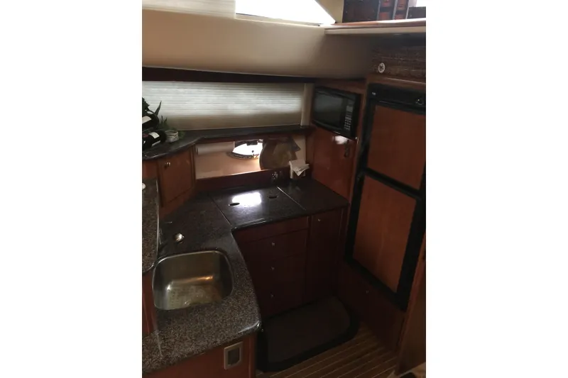 Slide: The Image of 2006 Meridian 408 Motoryacht kitchen with granite countertops, sink, and built-in appliances. - 18