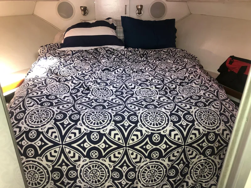 Slide: The Image of Cozy cabin bed in 1990 Trojan 40 Sport Fisherman boat with patterned bedding. - 10