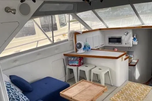 Slide: The Image of Interior of 1990 Trojan 40 Sport Fisherman with seating, kitchenette, and nautical decor. - 5