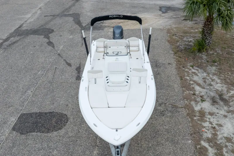 Slide: The Image of 2017 Robalo 206 Cayman boat on pavement, featuring sleek design and spacious seating. - 11
