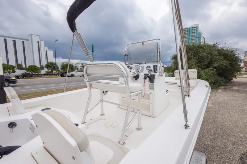 Slide: The Image of 2017 Robalo 206 Cayman boat with console, parked near urban buildings. - 22