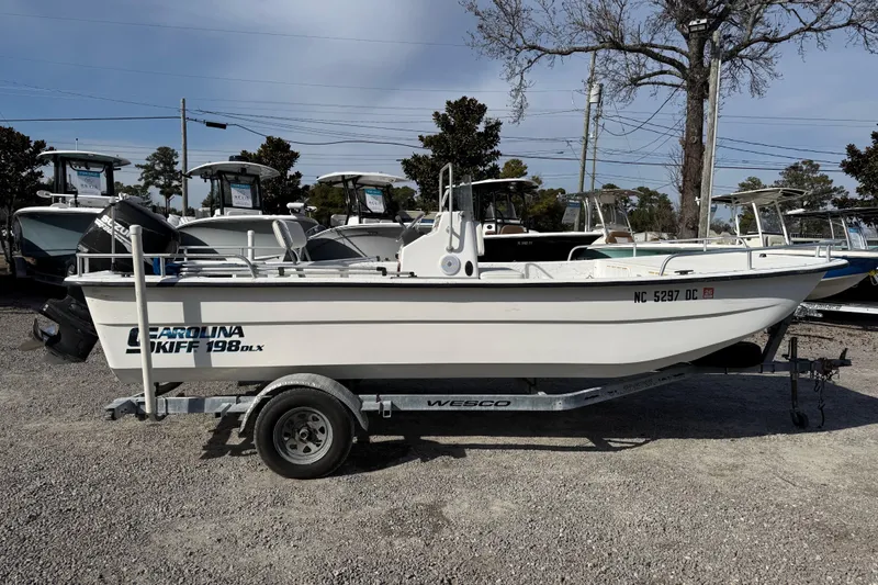 The Image of 2006 Carolina Skiff 1980 DLX boat on trailer, parked outdoors. - 1